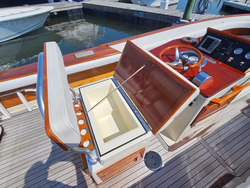 Slide: The Image of 1989 Boca Grande 26 boat interior with open storage compartment and steering console. - 11