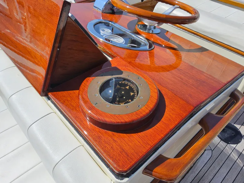 Slide: The Image of 1989 Boca Grande 26 boat dashboard with wooden finish and compass. - 17