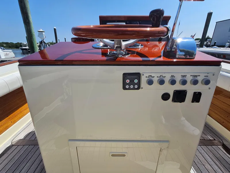 Slide: The Image of 1989 Boca Grande 26 boat helm with wooden steering wheel and control panel. - 18