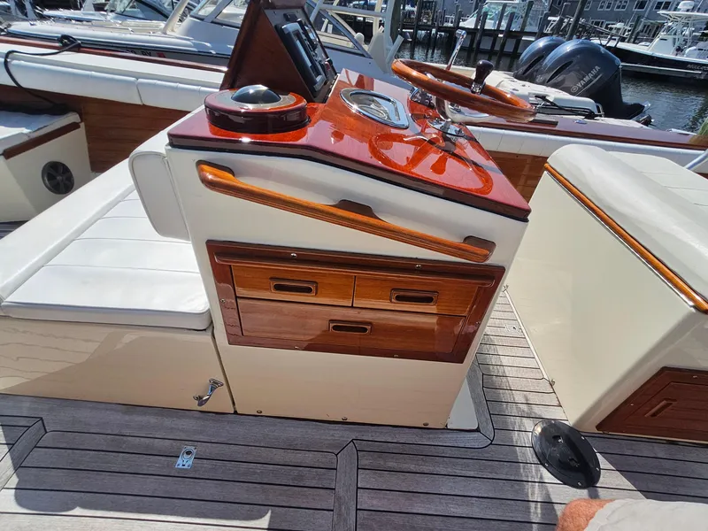 Slide: The Image of 1989 Boca Grande 26 boat interior with polished wood dashboard and seating. - 19