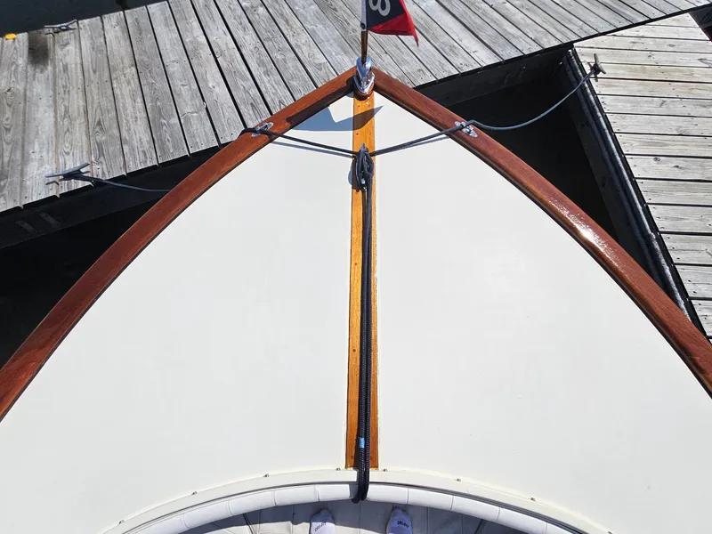 Slide: The Image of Bow of 1989 Boca Grande 26 boat docked at wooden pier. - 26