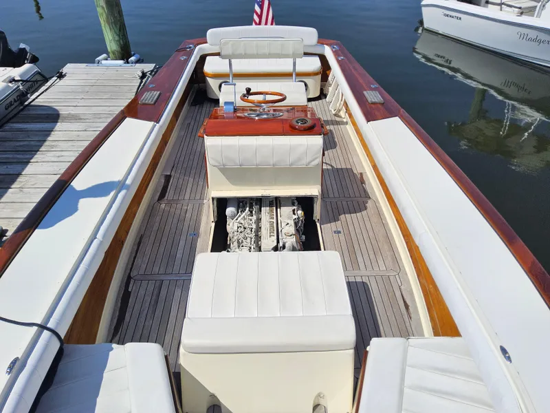 Slide: The Image of 1989 Boca Grande 26 boat interior with open engine compartment, docked at marina. - 27