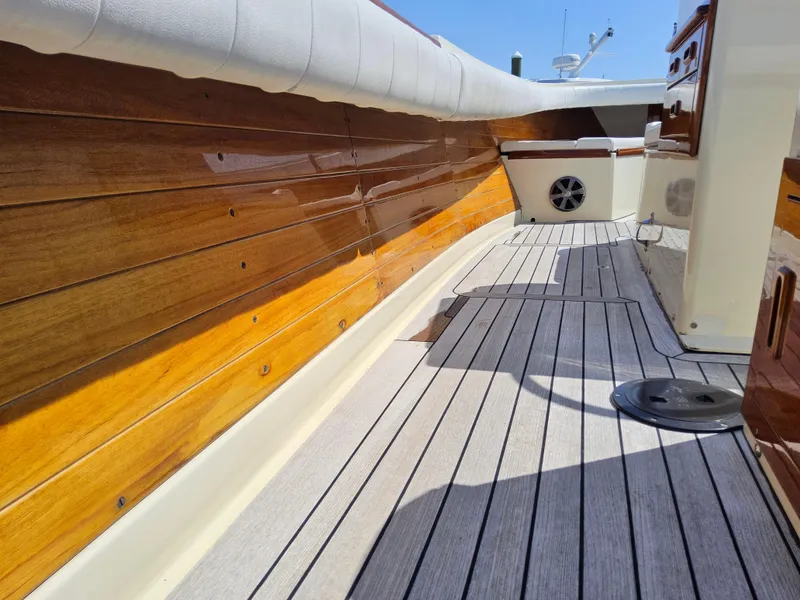 Slide: The Image of 1989 Boca Grande 26 boat deck with polished wood and cushioned seating. - 33