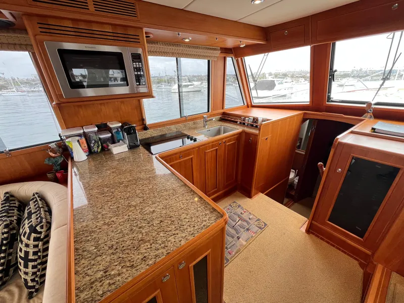 Slide: The Image of Luxurious 2008 Grand Banks 47 Heritage EU yacht interior with modern kitchen and scenic window views. - 11