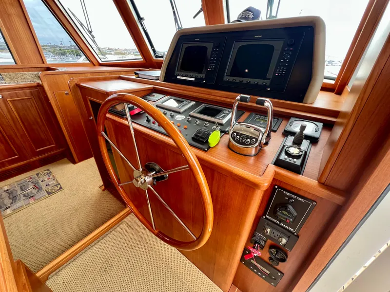 Slide: The Image of 2008 Grand Banks 47 Heritage EU helm with wooden wheel and navigation instruments. - 18