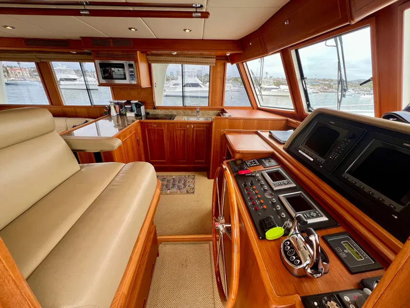 Slide: The Image of Luxurious 2008 Grand Banks 47 Heritage EU yacht interior with helm, leather seating, and panoramic windows. - 19