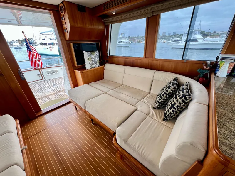 Slide: The Image of Luxurious interior of 2008 Grand Banks 47 Heritage EU yacht with plush seating and scenic marina view. - 23