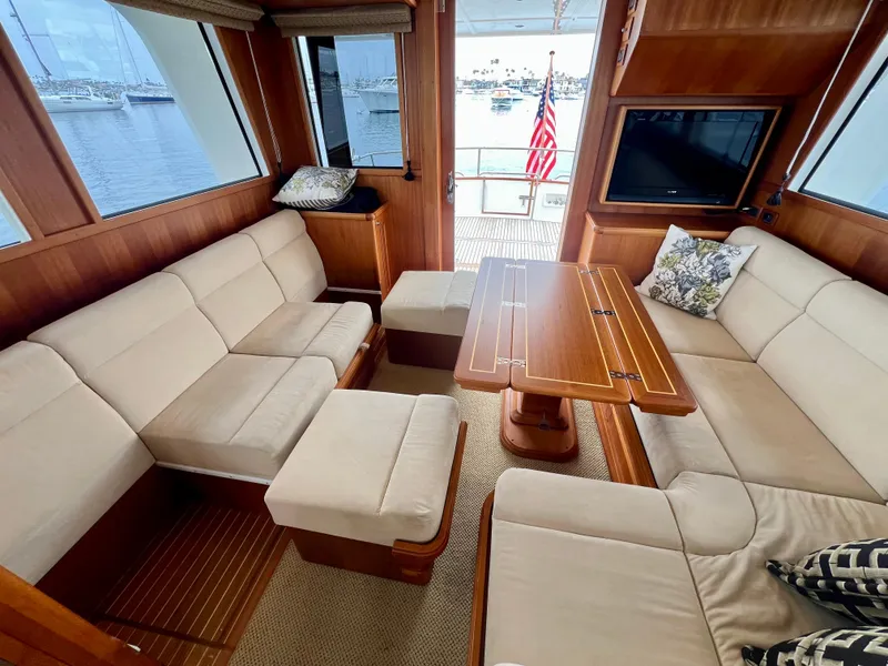 Slide: The Image of Luxurious interior of 2008 Grand Banks 47 Heritage EU yacht with plush seating and wooden table. - 25