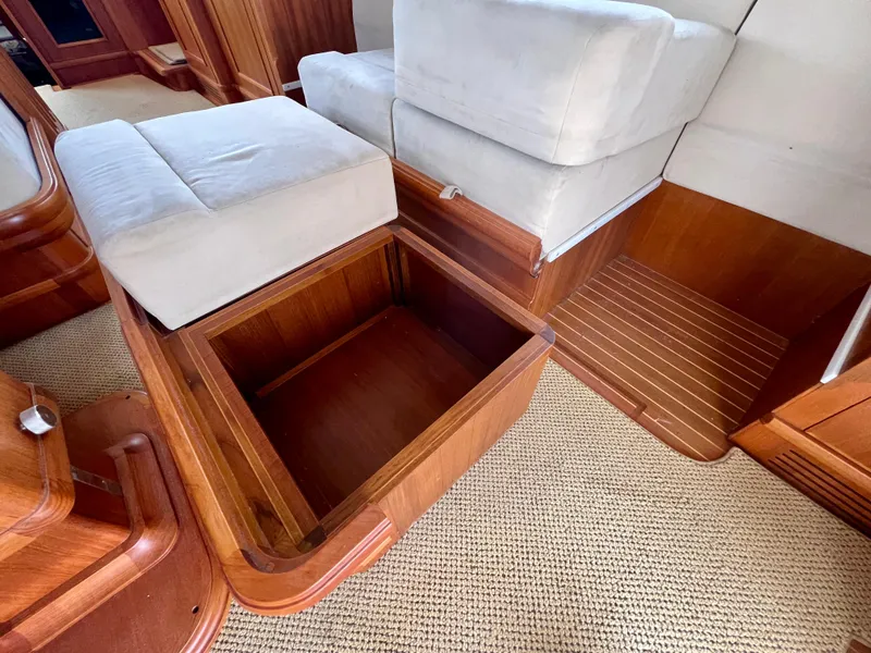 Slide: The Image of Interior of 2008 Grand Banks 47 Heritage EU with open wooden storage compartment. - 27