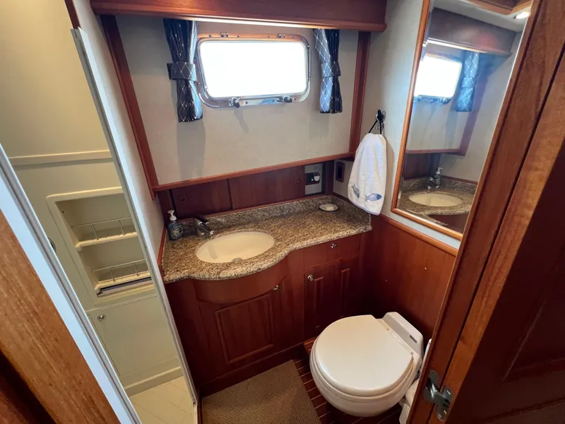 Slide: The Image of Luxurious 2008 Grand Banks 47 Heritage EU yacht bathroom with granite countertop and wooden cabinetry. - 29