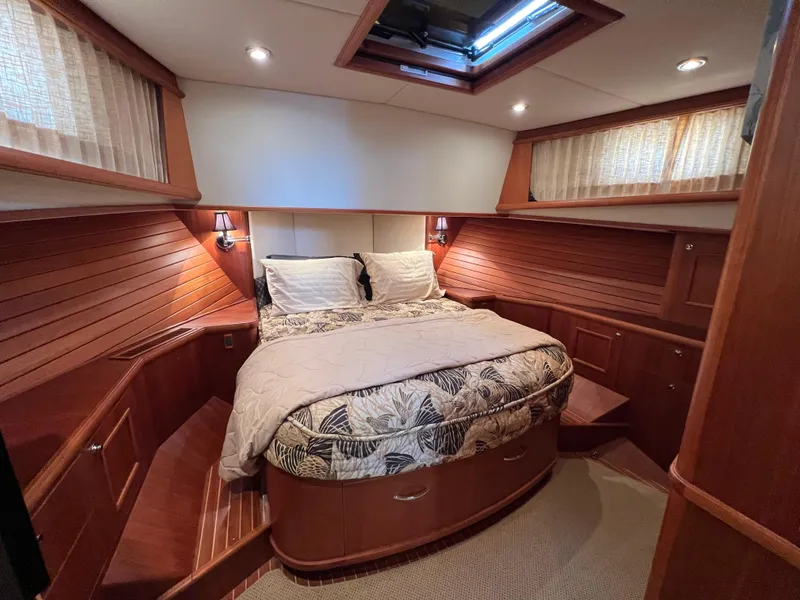 Slide: The Image of Luxurious 2008 Grand Banks 47 Heritage EU yacht cabin with elegant wood paneling and cozy bedding. - 33