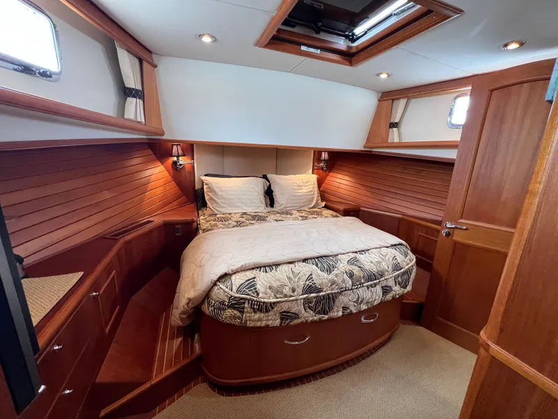 Slide: The Image of Luxurious 2008 Grand Banks 47 Heritage EU cabin with elegant wood paneling and cozy bedding. - 34