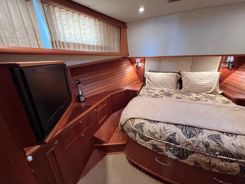Slide: The Image of Luxurious 2008 Grand Banks 47 Heritage EU yacht bedroom with wood paneling and cozy bedding. - 36