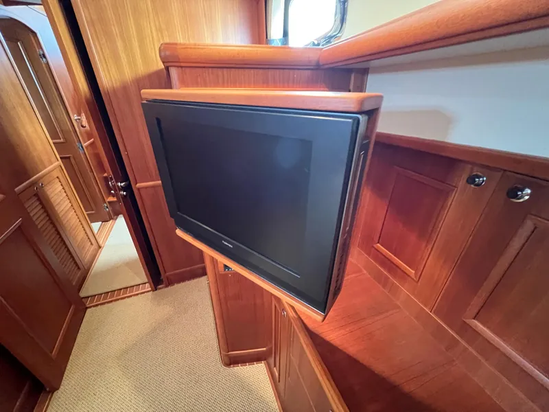 Slide: The Image of Interior of 2008 Grand Banks 47 Heritage EU with built-in TV and wooden cabinetry. - 37