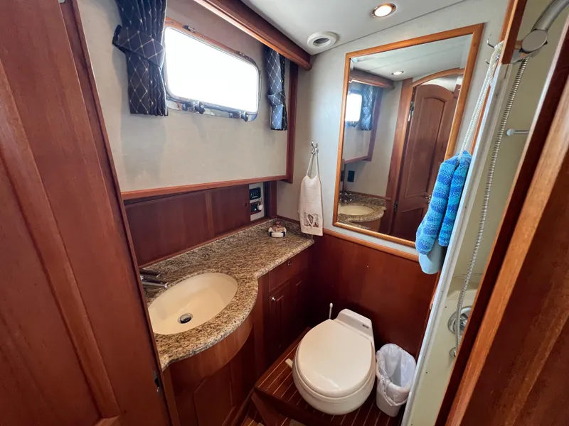Slide: The Image of Luxurious 2008 Grand Banks 47 Heritage EU yacht bathroom with granite countertop and wooden accents. - 38