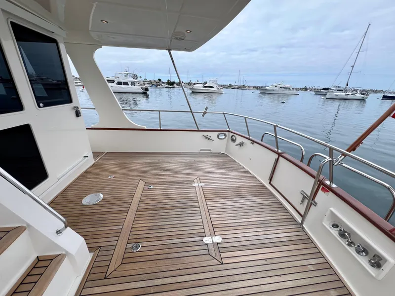 Slide: The Image of 2008 Grand Banks 47 Heritage EU yacht deck with wooden flooring, docked in a marina. - 42