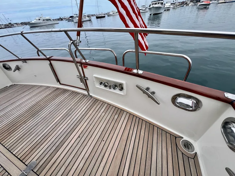 Slide: The Image of 2008 Grand Banks 47 Heritage EU yacht deck with wooden flooring and American flag. - 43