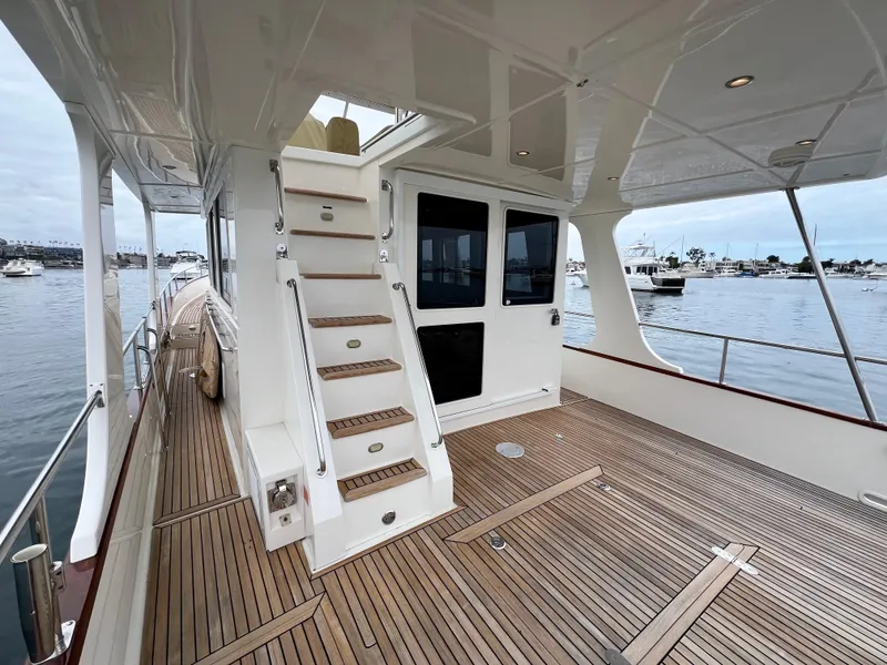 Slide: The Image of 2008 Grand Banks 47 Heritage EU yacht with teak deck and staircase, docked in marina. - 47