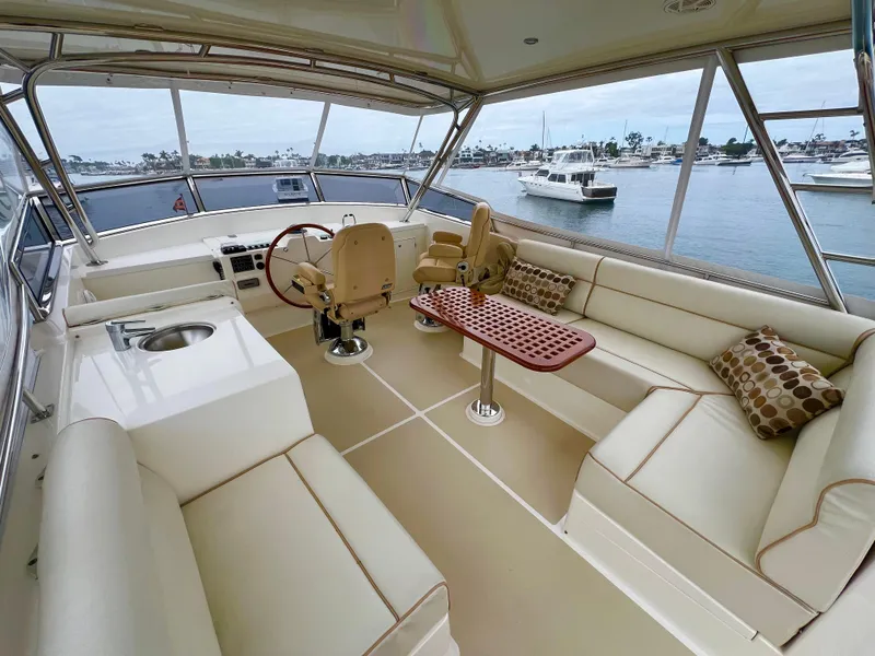 Slide: The Image of Luxurious 2008 Grand Banks 47 Heritage EU yacht interior with plush seating and scenic marina view. - 48