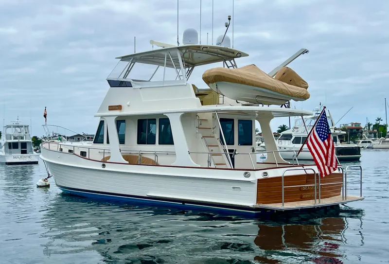 Slide: The Image of 2008 Grand Banks 47 Heritage EU yacht docked in a marina, displaying an American flag. - 5