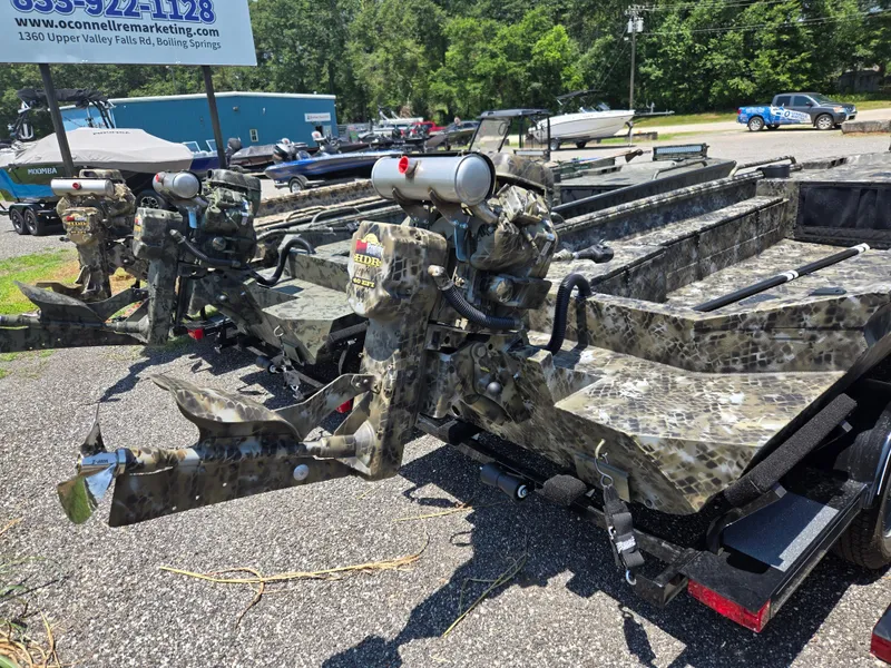 Slide: The Image of 2025 Excel 1754 F4 Shallow Water boats with camouflage design on display outdoors. - 16