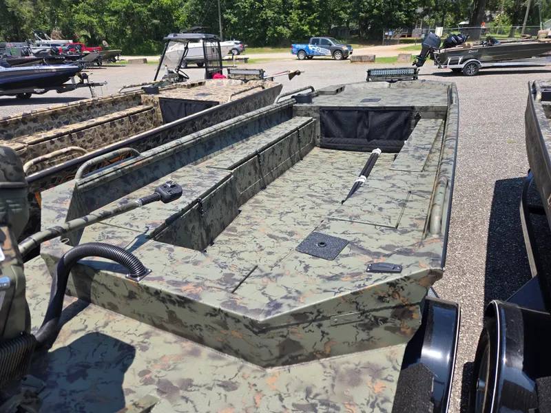 Slide: The Image of 2025 Excel 1754 F4 Shallow Water boat with camouflage design in a parking area. - 20