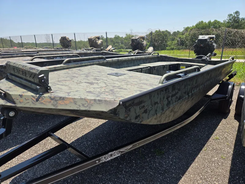 Slide: The Image of 2025 Excel 1754 F4 Shallow Water boat on trailer, camo design, parked outdoors. - 23