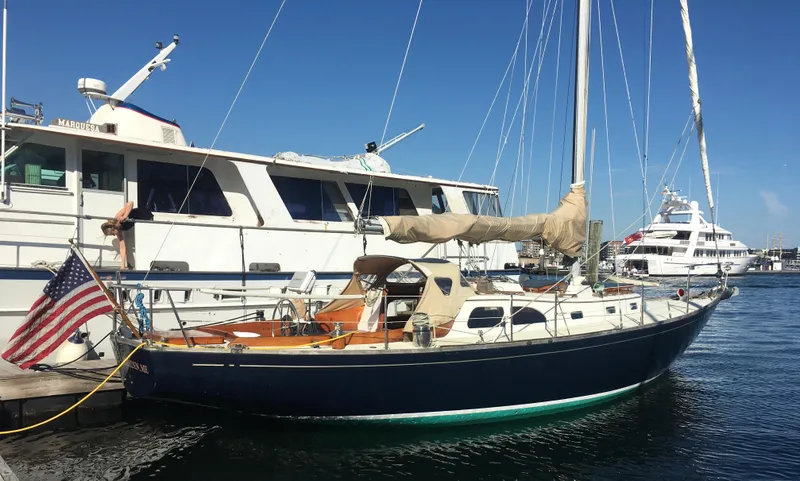 The Image of Sailboat LeComte Northeast 38, 1967 model, docked beside larger yacht in marina. - 0