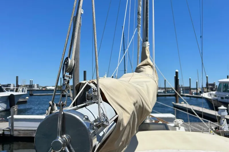 Slide: The Image of 1967 LeComte Northeast 38 sailboat docked at marina under clear blue sky. - 1