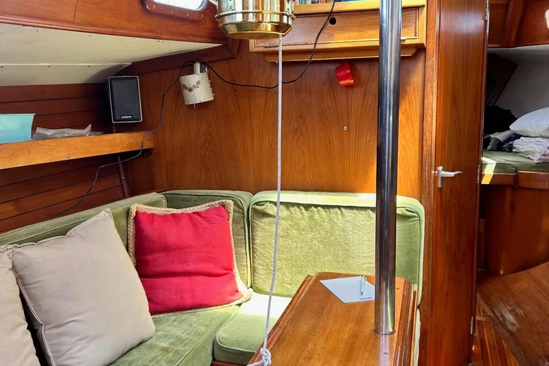 Slide: The Image of Interior of 1967 LeComte Northeast 38 sailboat with cozy seating and wooden finishes. - 7