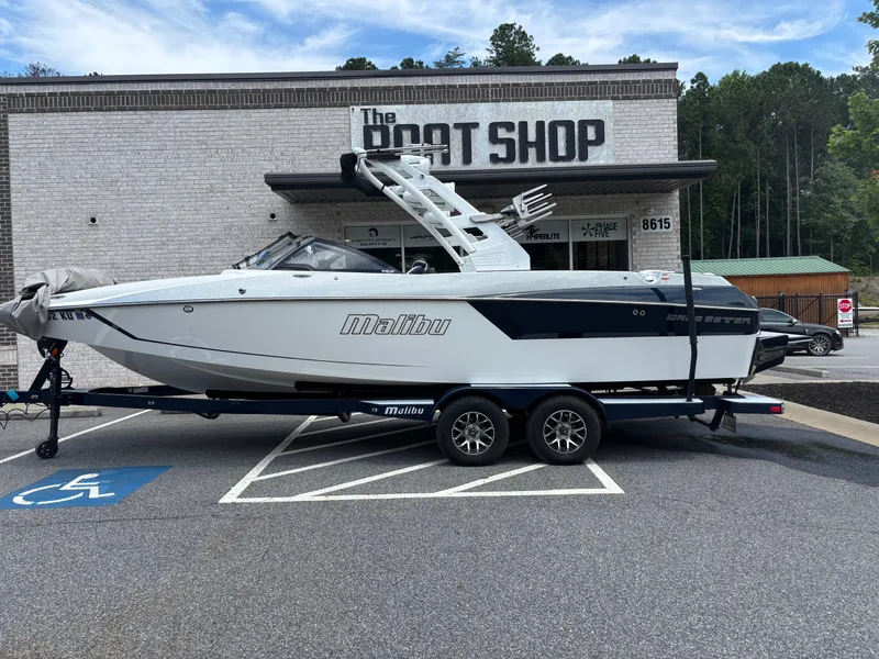 Slide: The Image of 2019 Malibu Wakesetter 24 MXZ boat with metallic finish and logo detail. - 2