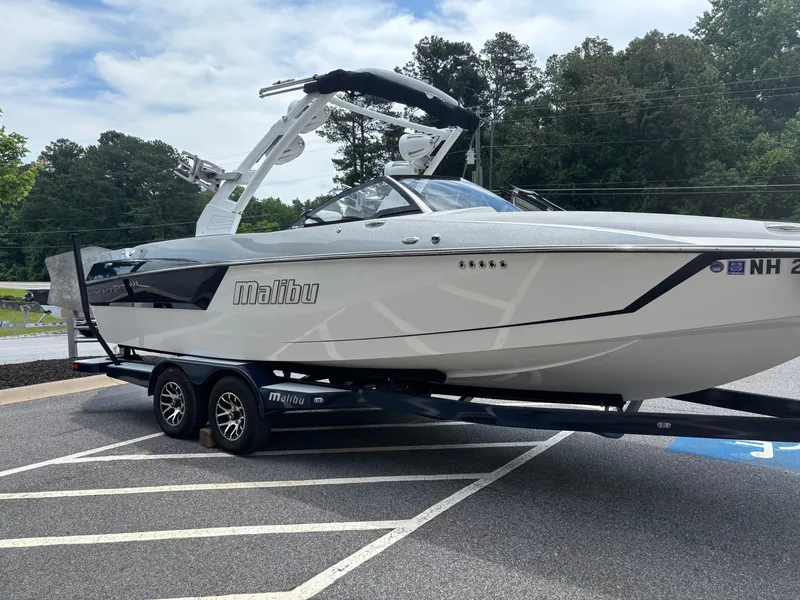Slide: The Image of 2019 Malibu Wakesetter 24 MXZ boat on trailer, parked outdoors. - 4