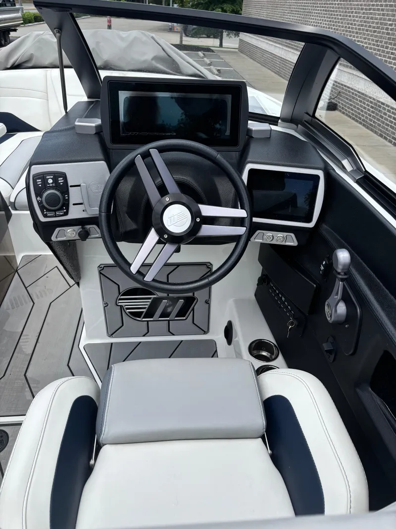 Slide: The Image of 2019 Malibu Wakesetter 24 MXZ boat cockpit with modern steering and digital displays. - 7