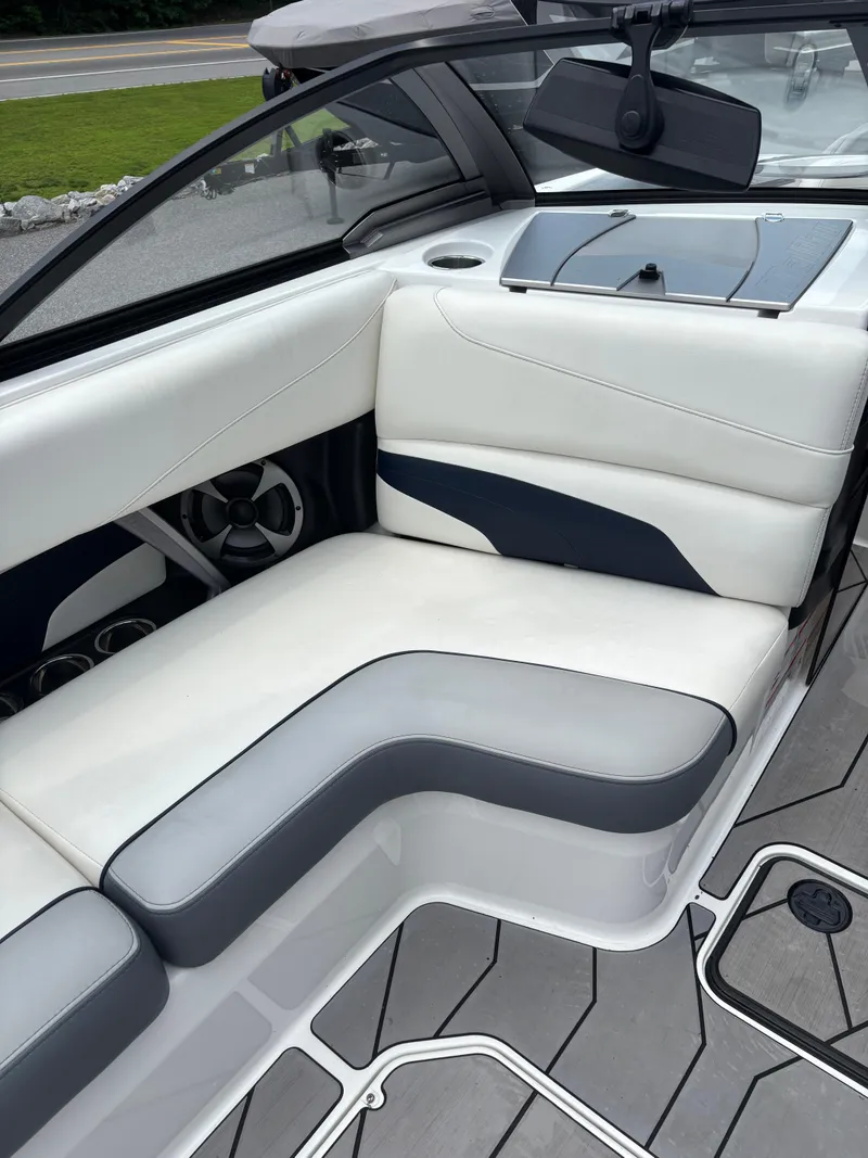 Slide: The Image of 2019 Malibu Wakesetter 24 MXZ interior with white and gray seating. - 8