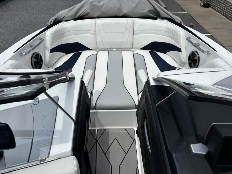 Slide: The Image of 2019 Malibu Wakesetter 24 MXZ boat interior with sleek white and gray seating. - 9