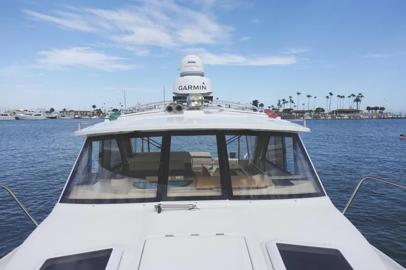 Slide: The Image of 2015 Cutwater 30 Sedan LE boat on calm water with clear sky. - 13