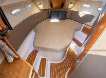 Slide: The Image of 2015 Cutwater 30 Sedan LE cabin interior with wood flooring and cushioned seating. - 17