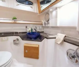 Slide: The Image of 2015 Cutwater 30 Sedan LE bathroom with modern fixtures and blue sink. - 19