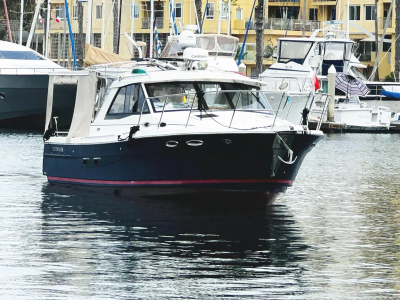 Slide: The Image of 2015 Cutwater 30 Sedan LE boat docked in a marina with other vessels. - 6