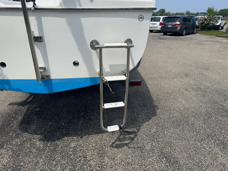 Slide: The Image of Catalina 22 Sport 2006 boat with a metal boarding ladder on a paved surface. - 7