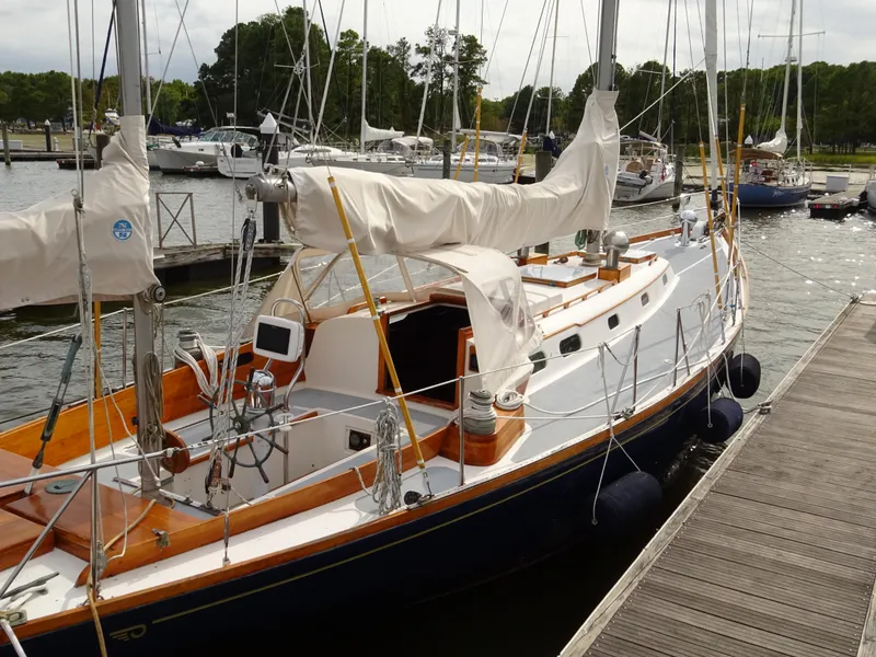 Slide: The Image of Hinckley Bermuda 40 Custom sailboat, 1964 model, docked at a marina with covered sails. - 10