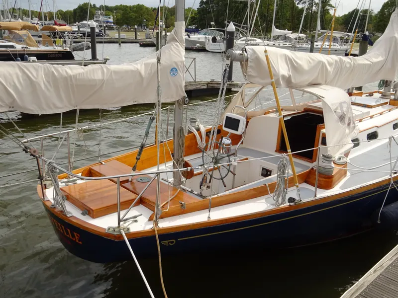 Slide: The Image of 1964 Hinckley Bermuda 40 Custom sailboat docked at a marina, showcasing classic design. - 11