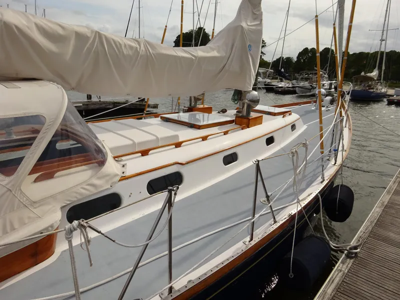 Slide: The Image of 1964 Hinckley Bermuda 40 Custom sailboat docked at marina, showcasing classic design and craftsmanship. - 12