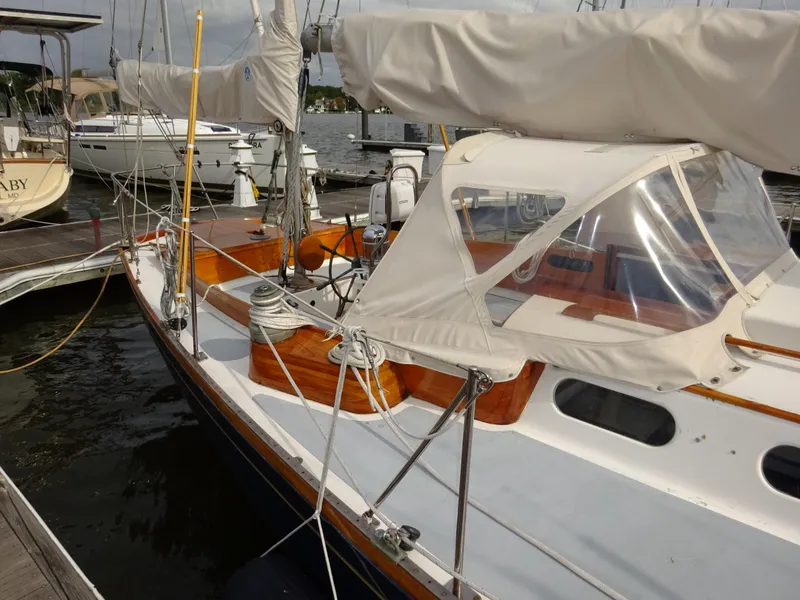 Slide: The Image of 1964 Hinckley Bermuda 40 Custom sailboat docked, featuring classic design and wooden accents. - 13