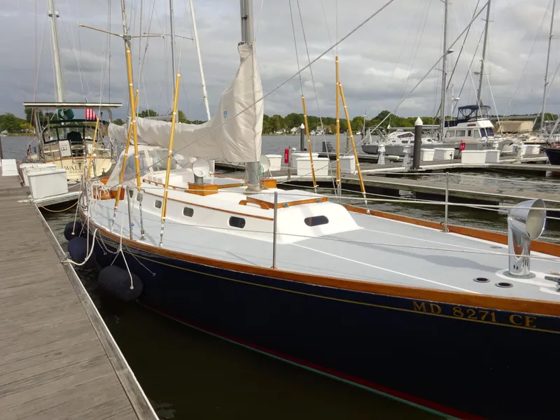 Slide: The Image of Hinckley Bermuda 40 Custom 1964 sailboat docked at marina, featuring classic design and wooden accents. - 15
