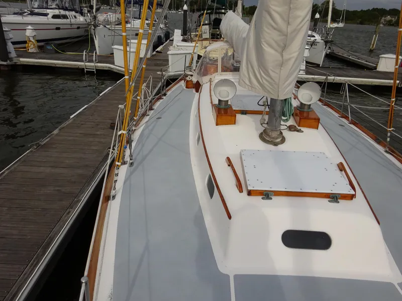 Slide: The Image of Hinckley Bermuda 40 Custom 1964 sailboat docked, showcasing deck and mast details. - 18