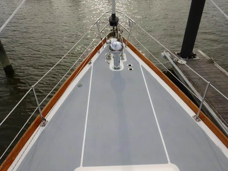 Slide: The Image of Bow view of 1964 Hinckley Bermuda 40 Custom sailboat docked by the water. - 19