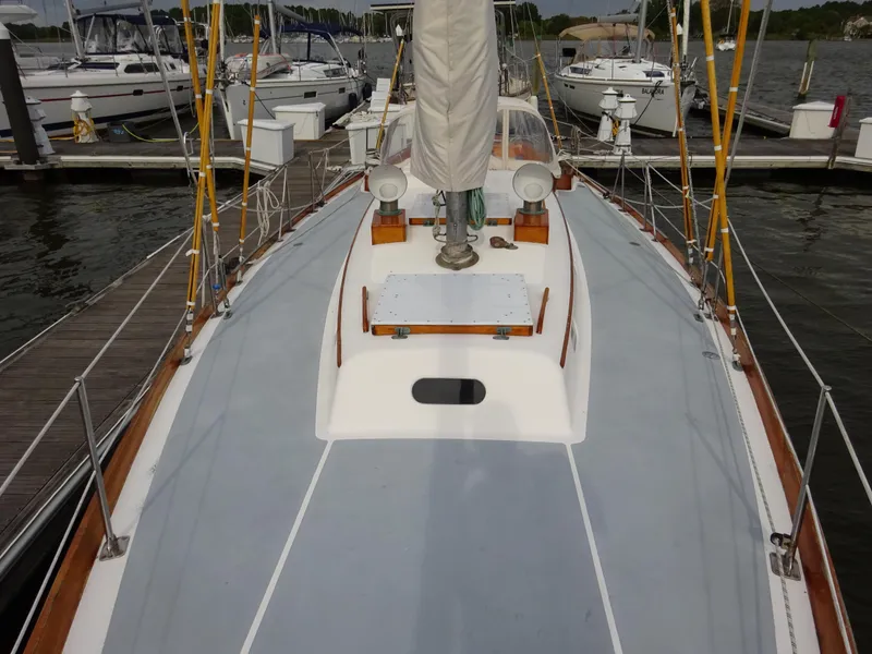 Slide: The Image of 1964 Hinckley Bermuda 40 Custom sailboat docked at marina, showcasing deck and mast. - 21