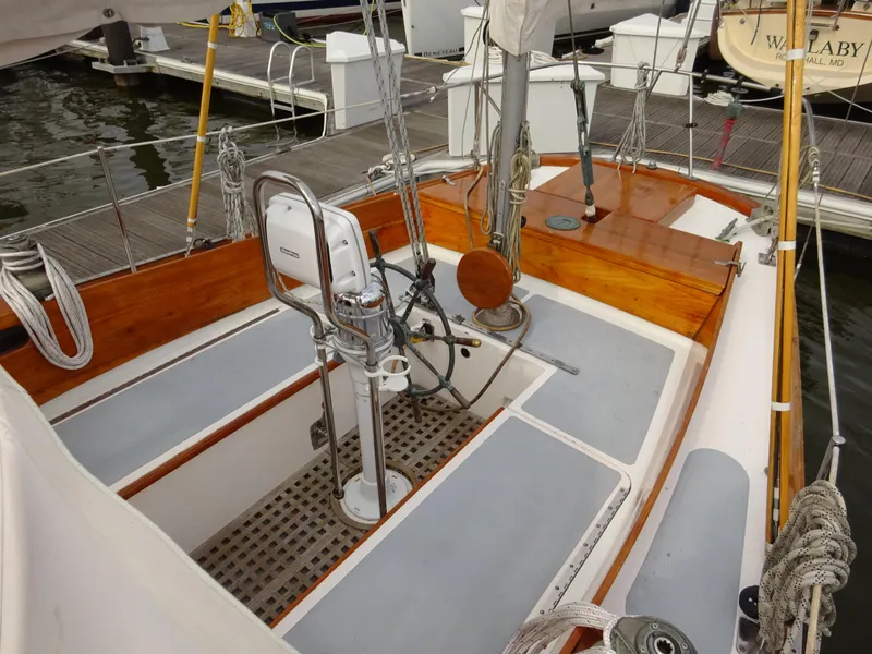 Slide: The Image of 1964 Hinckley Bermuda 40 Custom sailboat cockpit with wooden accents and steering wheel. - 24