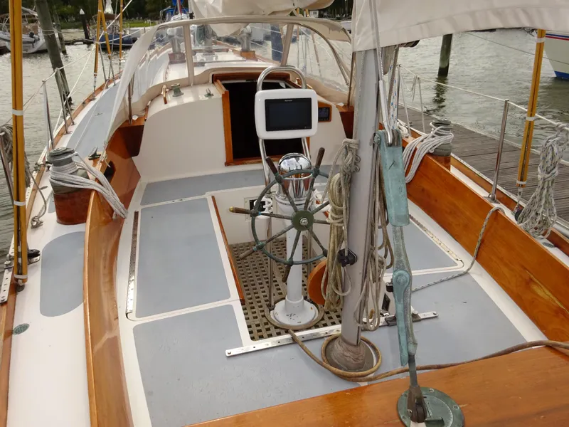 Slide: The Image of 1964 Hinckley Bermuda 40 Custom sailboat cockpit with wooden accents and steering wheel. - 25